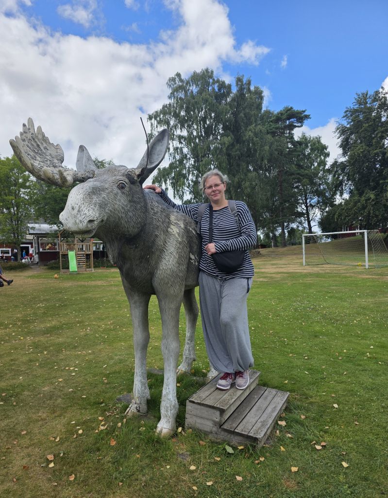 Erinnerungsfoto an einer großen Elchfigur im Elinge Älgpark in Schweden